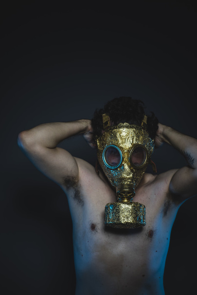 depression and danger man with golden gas mask - 写真・画像