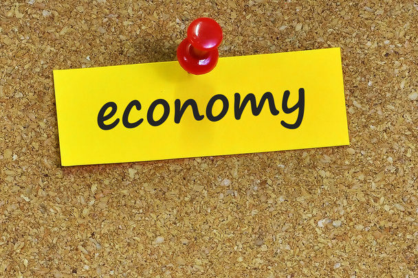 economy  word on notes paper with cork background - Photo, Image