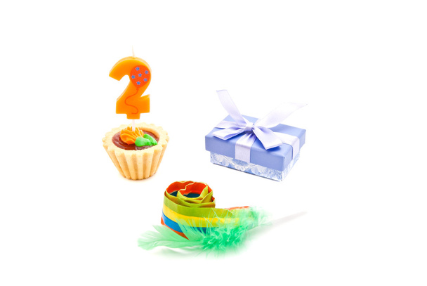 cake with two years birthday candle, whistle and gift on white  - Foto, Imagem