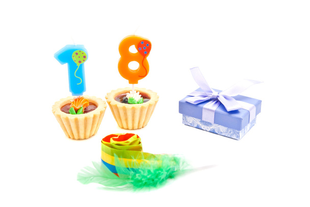 cakes with eighteen years birthday candles, whistle and gift on  - Фото, зображення