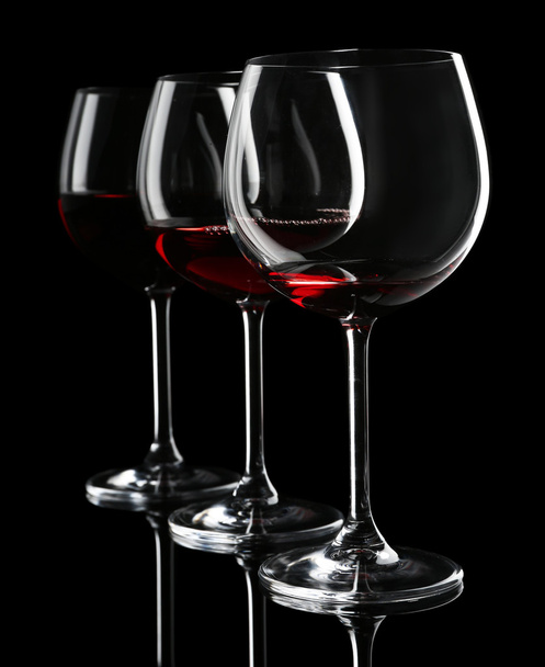 Glasses of wine on black - Фото, изображение