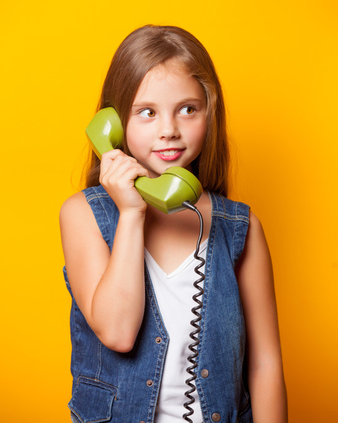 Young surprised girl with green handset - Foto, Bild
