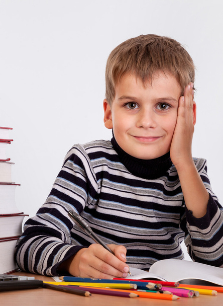 Cute schoolboy is writting - Φωτογραφία, εικόνα