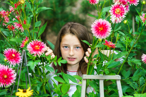 Teenage schoolgirl portrait with natural flowers - Photo, Image