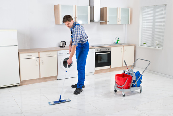 Worker Mopping Floor - Фото, изображение