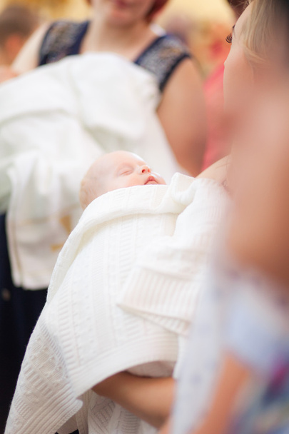 Mother hold baby on ceremony of child baptism - Photo, image