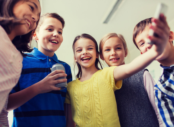 group of school kids with smartphone and soda can - Zdjęcie, obraz