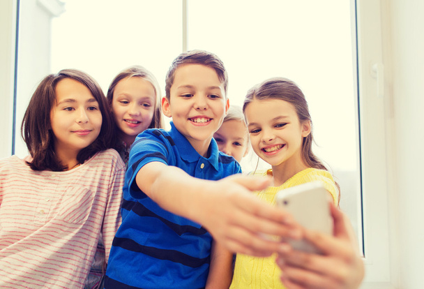 group of school kids taking selfie with smartphone - 写真・画像