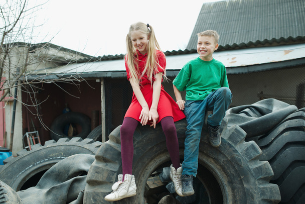 children playing in junkyard tires - Photo, image