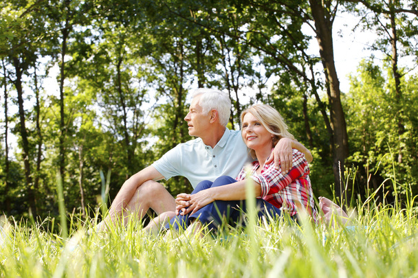Relaxing senior couple in the nature - Photo, image