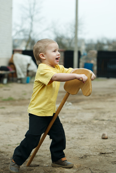 boy playing with wooden horse - Fotografie, Obrázek