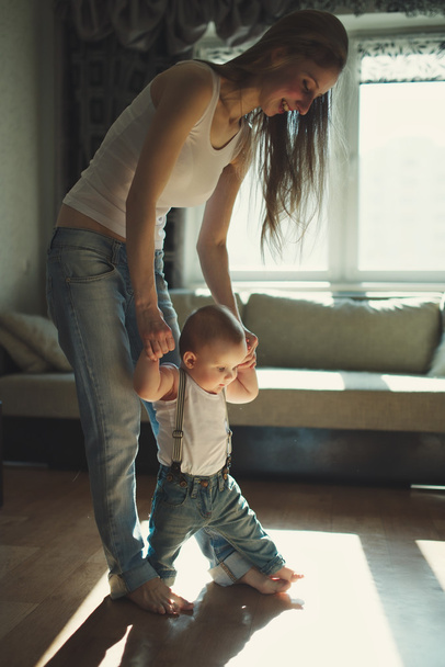 beautiful mother teaches baby to walk - 写真・画像