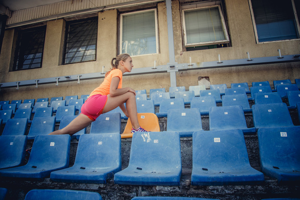 Young female in sportswear doing exercises  - Fotografie, Obrázek