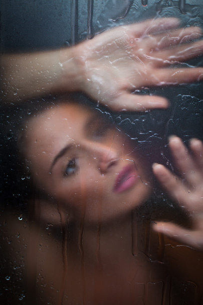 Sensual girl behind the glass - Фото, изображение