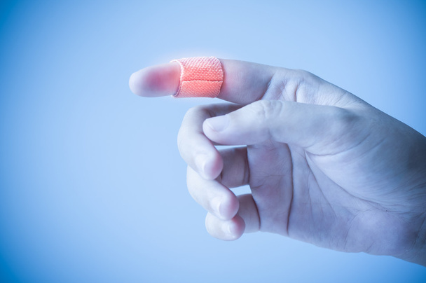Finger with adhesive bandage - Фото, зображення