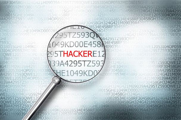 reading the word hacker on computer screen with a magnifying gla - Foto, Imagem