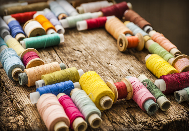 Bobbins with colorful threads - 写真・画像