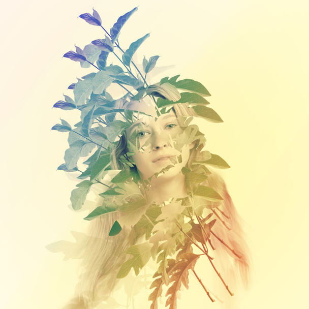 Young woman with abstract leaves - Φωτογραφία, εικόνα