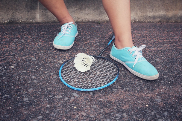 Sneakers with shuttlecocks and badminton racket. - Valokuva, kuva