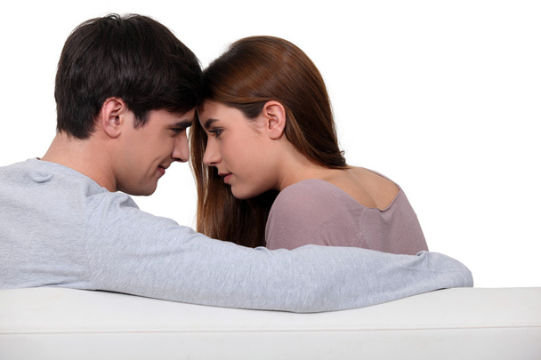 Young couple in love sitting on sofa - Foto, Imagen