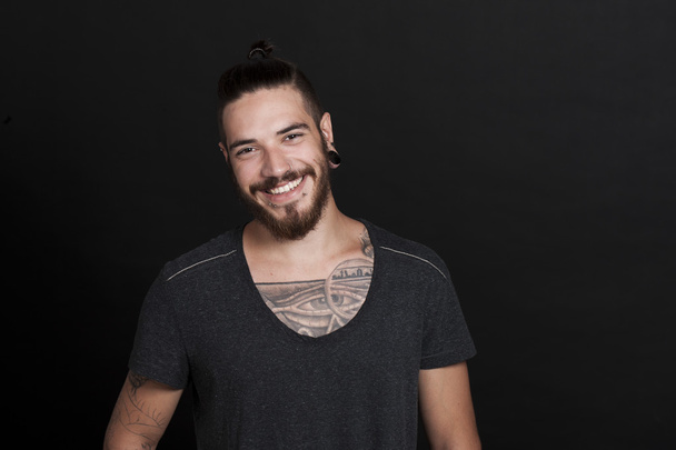 Friendly young tattoo man with pony tail - Foto, Imagen