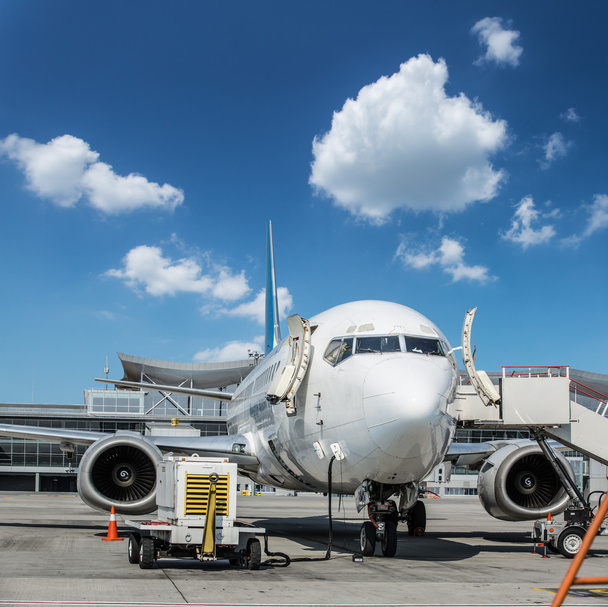 Ground service equipment and airplane in the airport. - Photo, Image