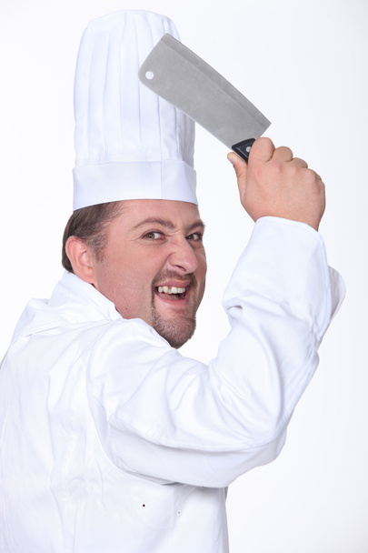 Chef in whites wielding a chopper - Fotoğraf, Görsel
