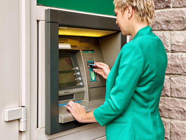 Mujer de negocios opera ATM
 - Foto, Imagen