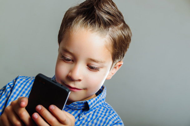 Cute boy using cell phone - Photo, image