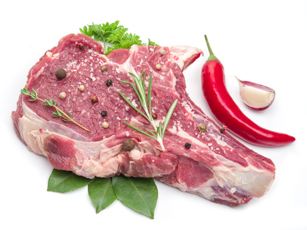 Raw beef steak with spices on the white background. - Photo, Image