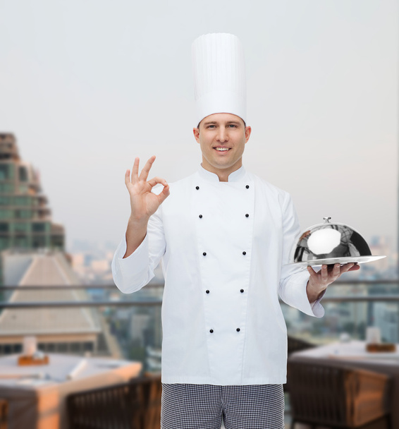 happy male chef cook with cloche showing ok sign - Valokuva, kuva