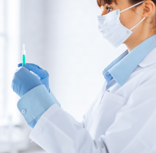 female doctor holding syringe with injection - Фото, изображение