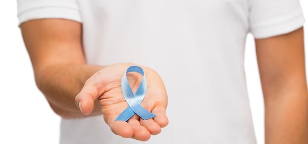 hand with blue prostate cancer awareness ribbon - Φωτογραφία, εικόνα