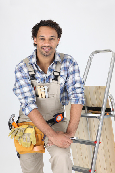 Carpenter stood by step-ladder - Фото, изображение