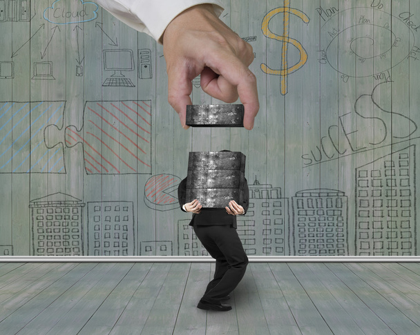 Man carrying concrete blocks with hand stacking business doodles - Photo, image