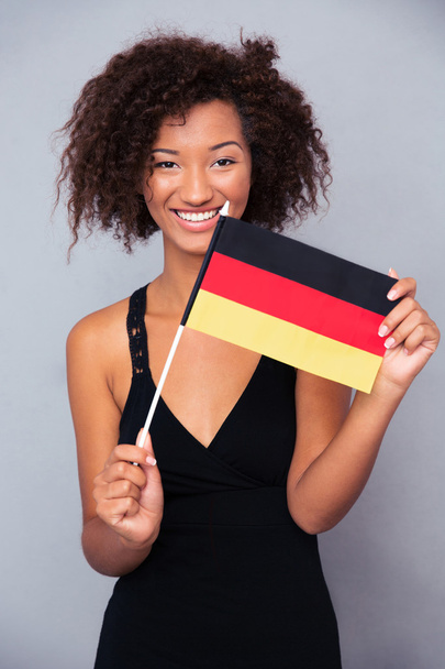Afro american woman holding Germany flag  - Fotografie, Obrázek