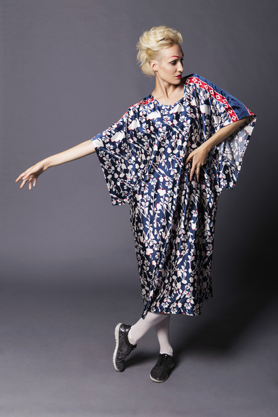 Young blonde transgender woman model in long blue pattern dress, - Photo, Image