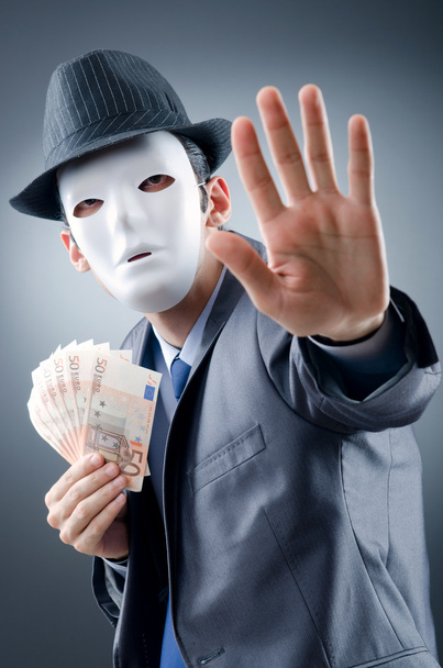 Businessman with money and mask - Foto, afbeelding