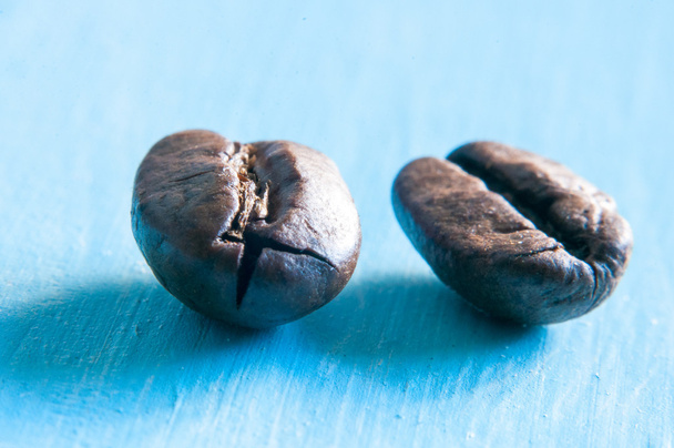 Closeup of coffee beans with focus on one - Photo, Image