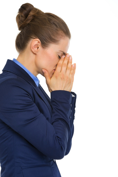 Closeup of tired businesswoman holding face in hands - Foto, Bild