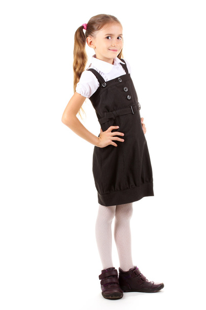 Beautiful little girl in school uniform isolated on white - Photo, Image