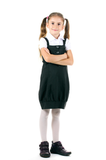 Beautiful little girl in school uniform isolated on white - Фото, изображение