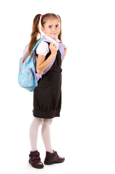 Portrait of beautiful little girl in school uniform with backpack. Isolated - Foto, Imagen