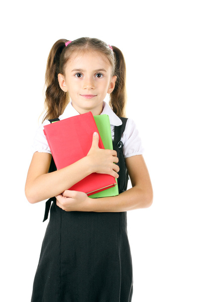 Beautiful little girl in school uniform and books isolated on white - Фото, зображення