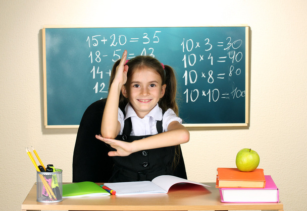 Little schoolchild in classroom near blackboard - 写真・画像