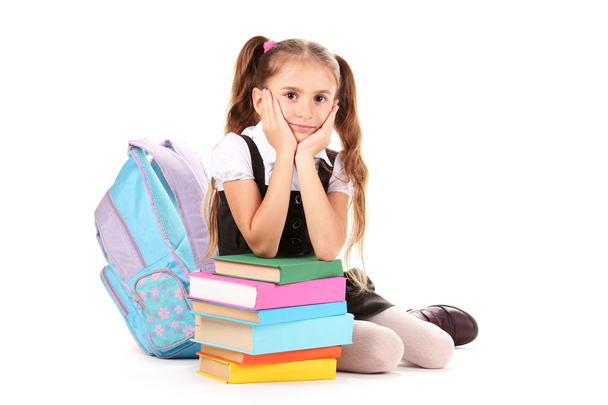 Beautiful little girl, books and a backpack isolated on white - 写真・画像