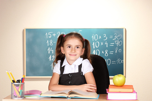 Little schoolchild in classroom near blackboard - Foto, immagini