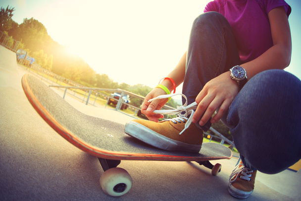 skateboarder tying shoelace - Photo, image