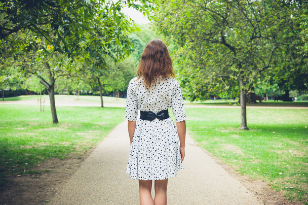 Young woman walking in park - Фото, зображення