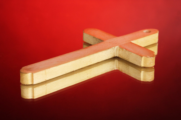 Wooden cross on red background - Photo, Image